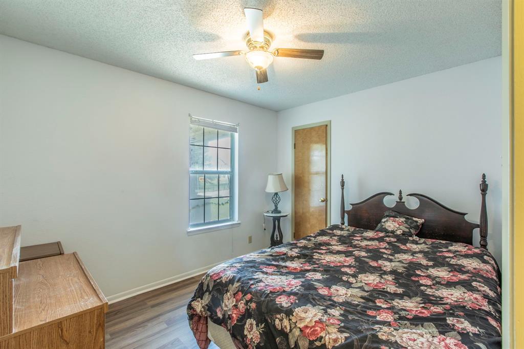 1936 Post Oak Drive Waco, TX 76705 - Photo 10 of 33 Bedroom featuring wood finished floors, a textured ceiling, and ceiling fan