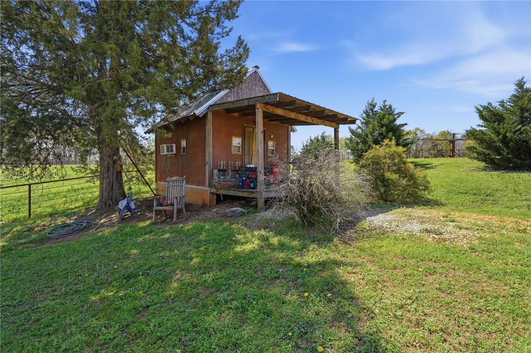 608 Five Forks Road Anderson, SC 29621 - Photo 19 of 43 This charming rustic cabin is nestled amongst green foliage, offering a peaceful rural escape.