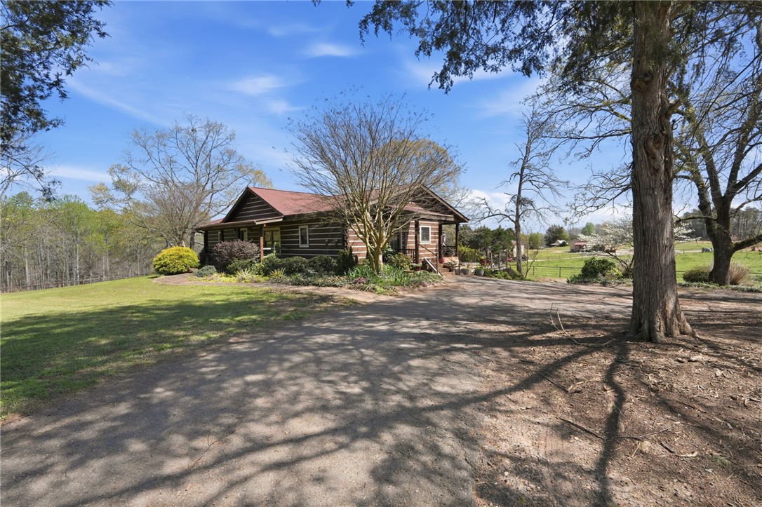 608 Five Forks Road Anderson, SC 29621 - Photo 21 of 43 This charming cabin home offers a serene escape, surrounded by lush trees and an expansive yard.