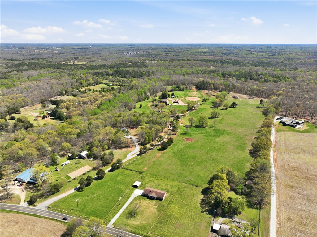 608 Five Forks Road Anderson, SC 29621 - Photo 23 of 43 Sprawling estate with lush green fields, mature trees, and a winding driveway for peaceful living.