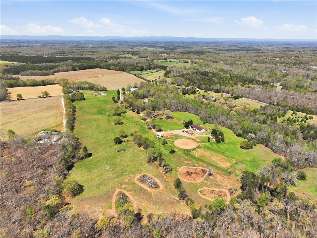 608 Five Forks Road Anderson, SC 29621 - Photo 24 of 43 Expansive rural landscape with fields and a distant mountain range under a clear sky.