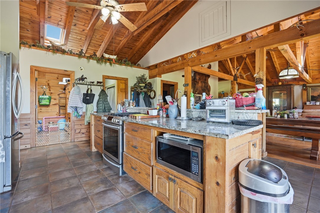 608 Five Forks Road Anderson, SC 29621 - Photo 28 of 43 This kitchen features a wood-paneled ceiling with skylights, ample cabinetry, and granite countertops.