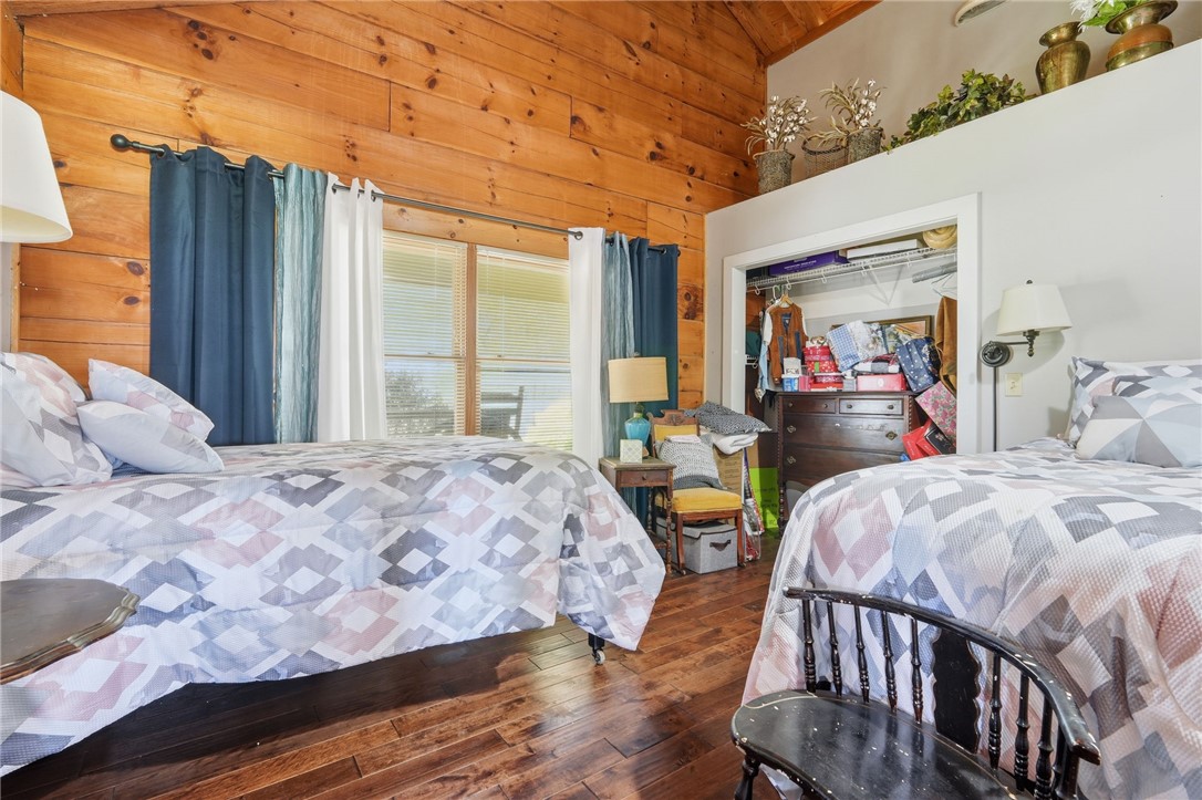 608 Five Forks Road Anderson, SC 29621 - Photo 32 of 43 This spacious bedroom features warm wood paneling and ample natural light, creating a bright and inviting atmosphere.