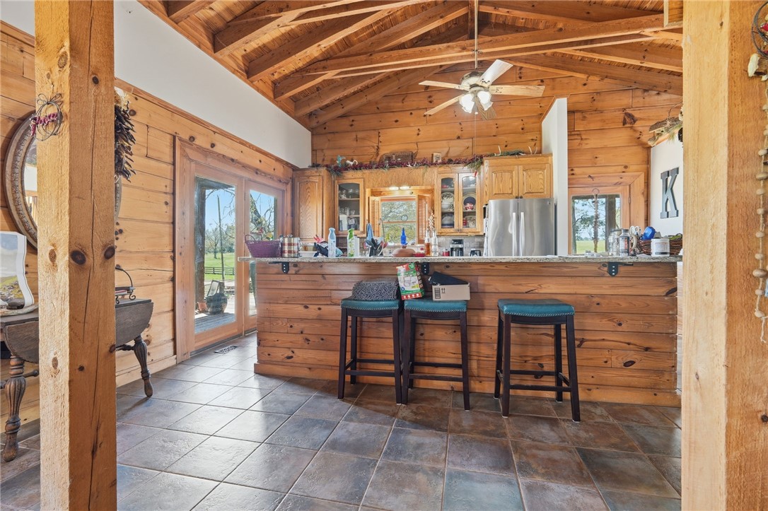 608 Five Forks Road Anderson, SC 29621 - Photo 34 of 43 This spacious kitchen boasts rustic wooden beams, inviting bar seating, and ample natural light.