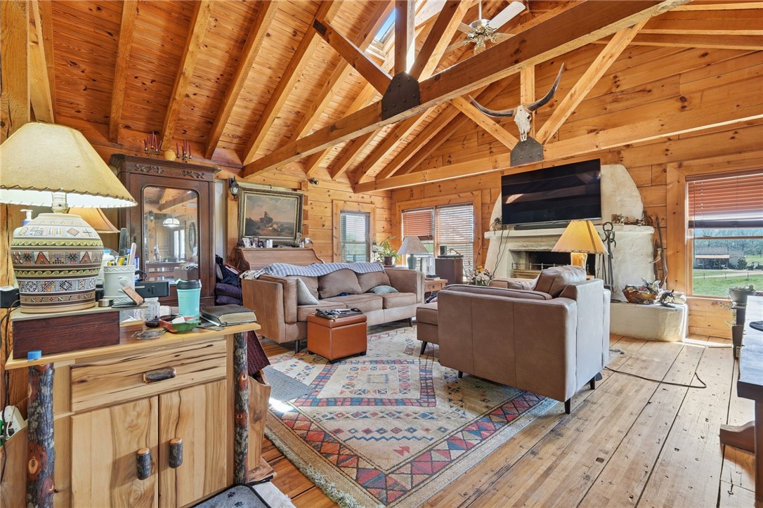 608 Five Forks Road Anderson, SC 29621 - Photo 35 of 43 This spacious living area showcases rich wood paneling and exposed beams, creating a cozy and inviting atmosphere.