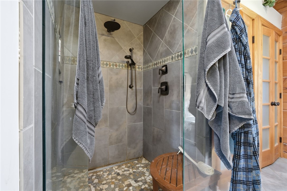 608 Five Forks Road Anderson, SC 29621 - Photo 40 of 43 This bathroom features a spacious shower with pebble flooring and tiled walls.