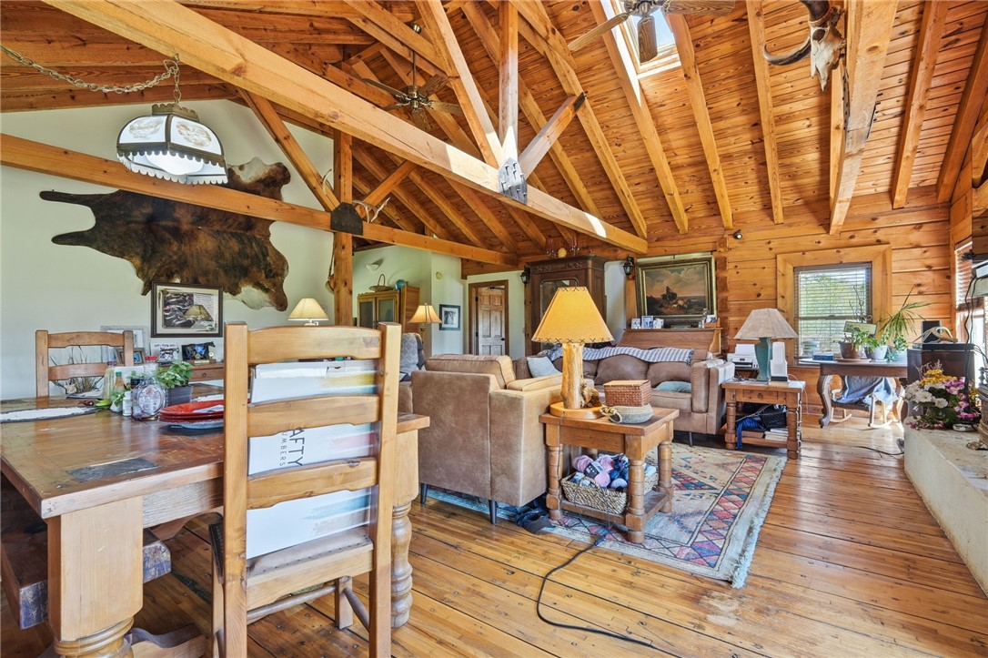 608 Five Forks Road Anderson, SC 29621 - Photo 43 of 43 This living area features a warm, inviting atmosphere with exposed wooden beams and rich wood flooring.