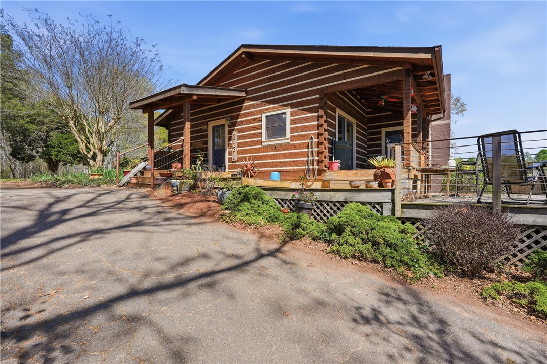 608 Five Forks Road Anderson, SC 29621 - Photo 6 of 43 This charming cabin home offers rustic appeal and a welcoming outdoor living space.