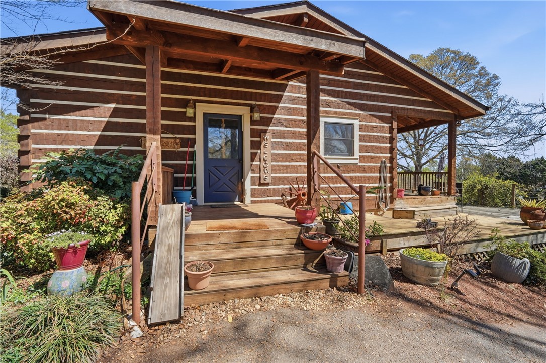 608 Five Forks Road Anderson, SC 29621 - Photo 8 of 43 This charming cabin home features a welcoming front porch, perfect for enjoying tranquil outdoor moments.