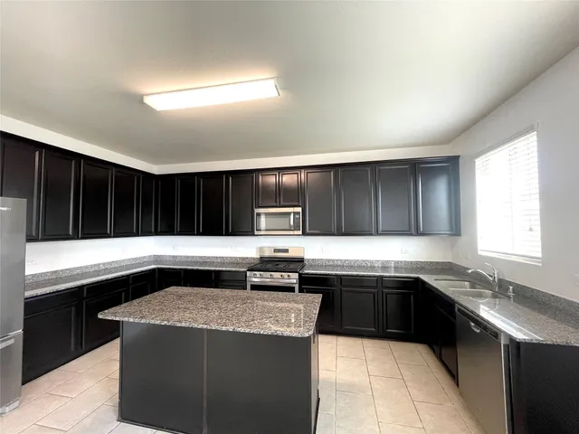 a kitchen with a sink and a stove