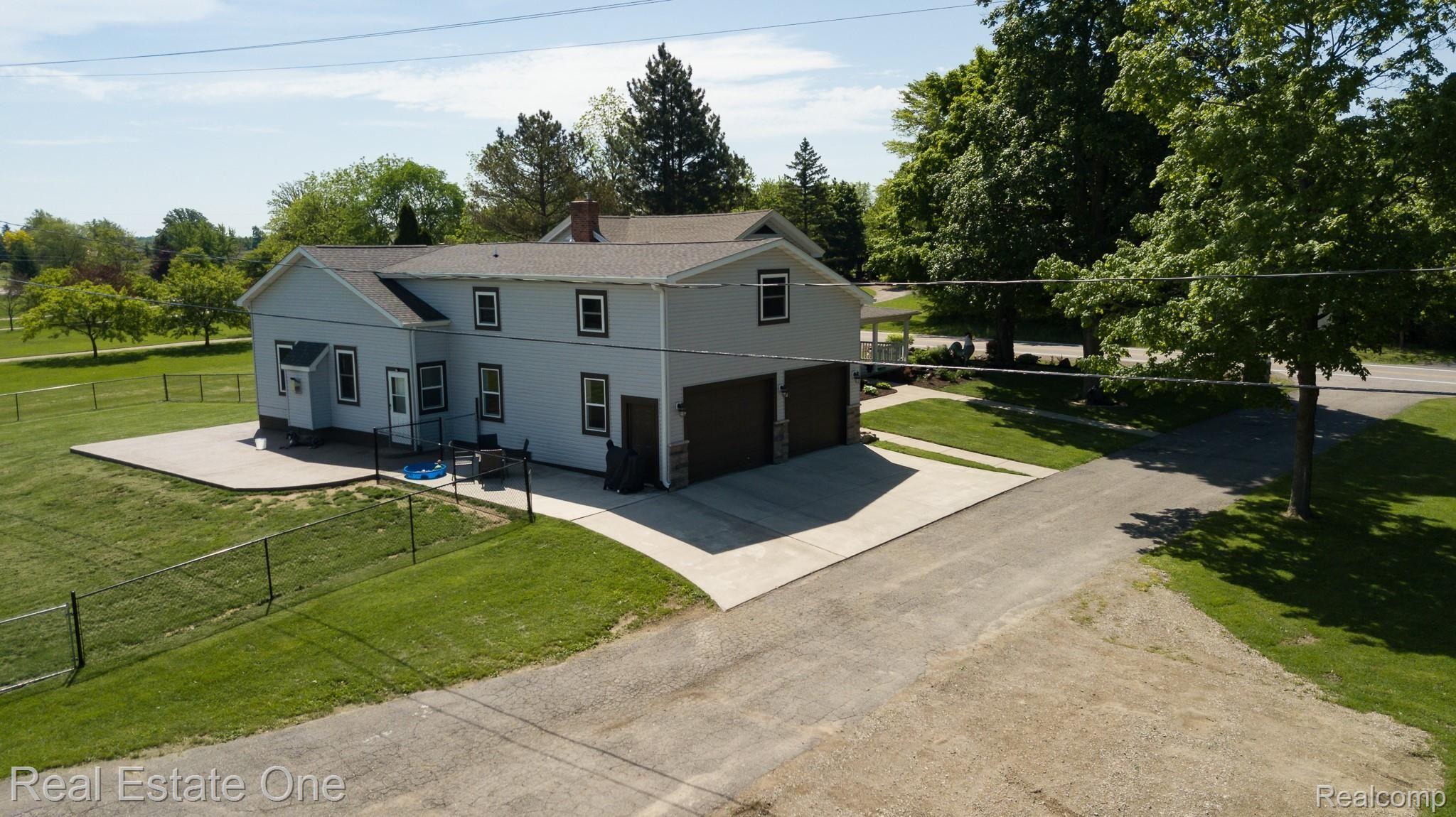 8047 Perry Road Grand Blanc, MI 48439 - Photo 5 of 48 Rear of Home - New in 2019 Exposed Aggregate Concrete patio and fenced in area.