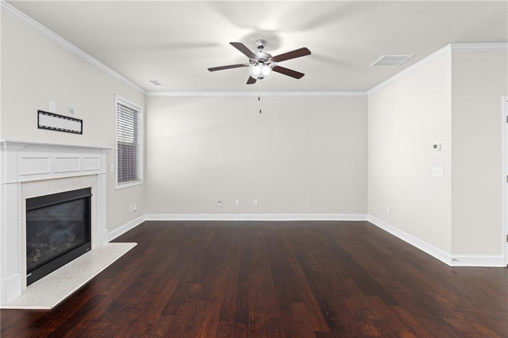 1925 Wheylon Drive Lawrenceville, GA 30044 - Photo 16 of 55 a view of an empty room with wooden floor and a fireplace