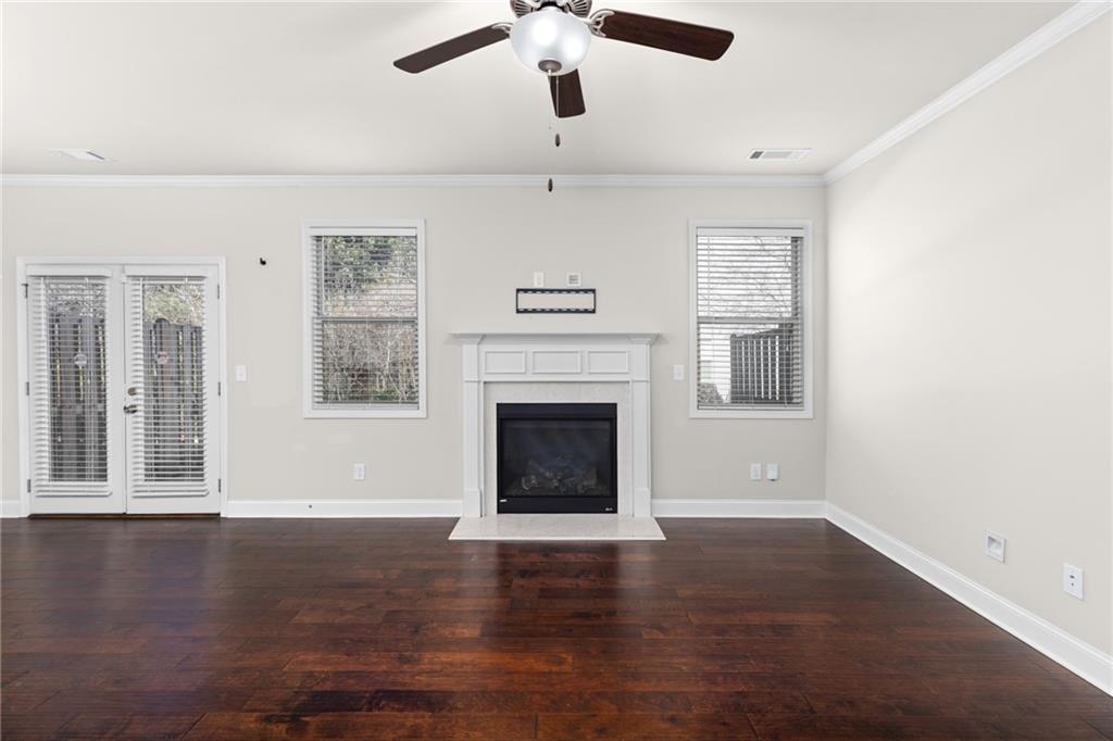 1925 Wheylon Drive Lawrenceville, GA 30044 - Photo 17 of 55 a view of an empty room with wooden floor fireplace and a window