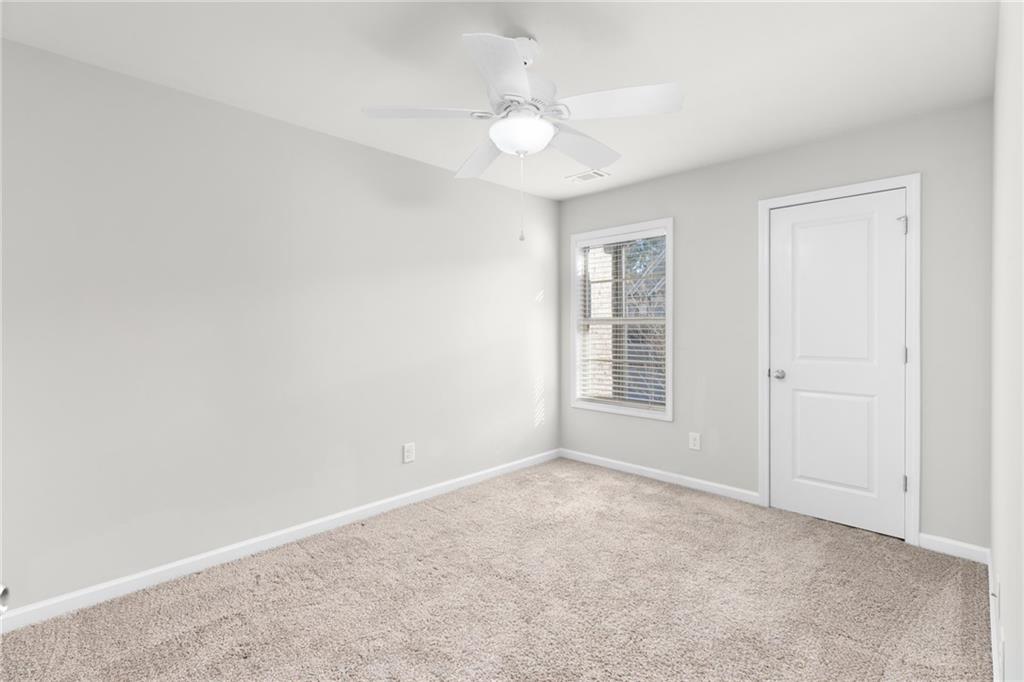 1925 Wheylon Drive Lawrenceville, GA 30044 - Photo 26 of 55 an empty room with windows and fan