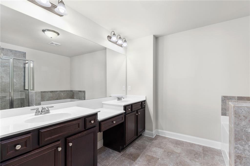 1925 Wheylon Drive Lawrenceville, GA 30044 - Photo 37 of 55 a bathroom with a double vanity sink and a mirror