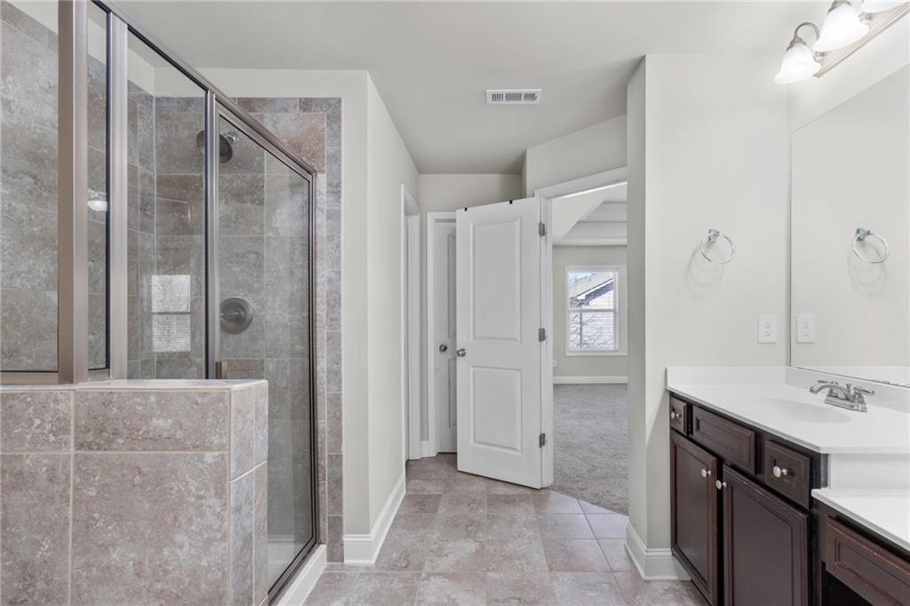 1925 Wheylon Drive Lawrenceville, GA 30044 - Photo 39 of 55 a bathroom with a shower and a sink