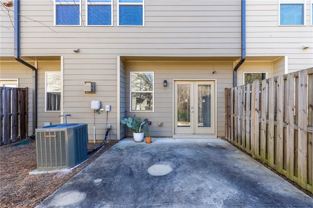 1925 Wheylon Drive Lawrenceville, GA 30044 - Photo 45 of 55 a view of a patio with table and chairs and wooden fence