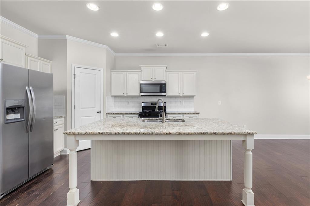 1925 Wheylon Drive Lawrenceville, GA 30044 - Photo 7 of 55 a kitchen with granite countertop white cabinets and stainless steel appliances