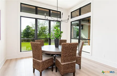 a view of a patio with a table and chairs