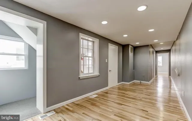 a bathroom with a granite countertop sink mirror and a bathtub