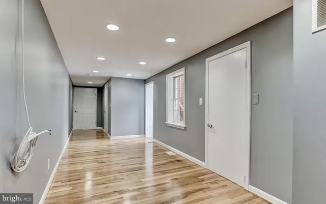 a view of staircase with white walls and white door