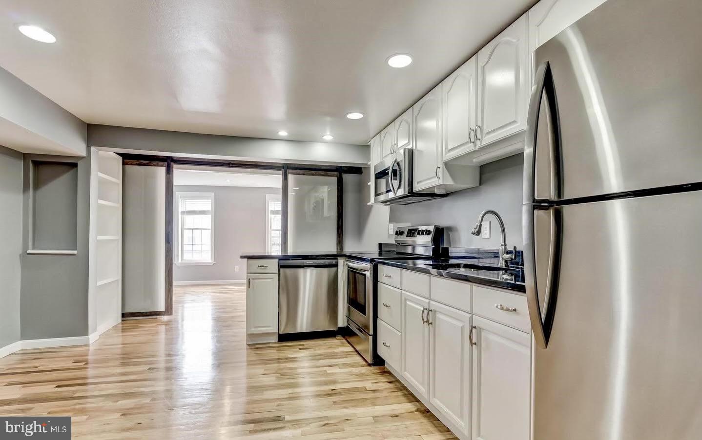 1049 South Charles Street Baltimore, MD 21230 - Photo 8 of 33 a kitchen with stainless steel appliances granite countertop a refrigerator a stove and a sink