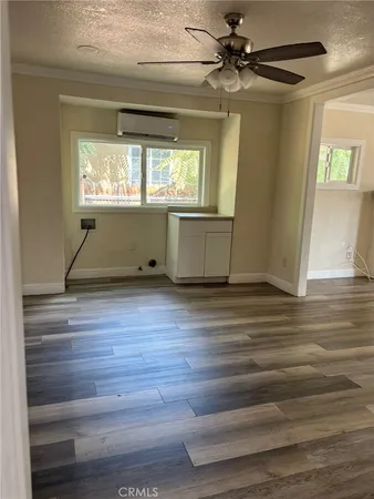 a view of a room with wooden floor
