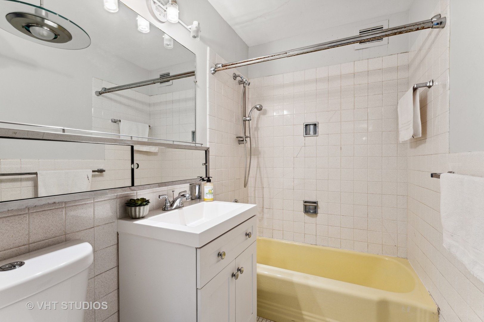 6301 North Sheridan Road, Unit 2U Chicago, IL 60660 - Photo 8 of 12 a bathroom with a sink mirror vanity and shower