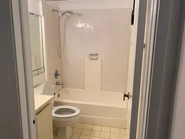 a bathroom with a tub a sink and a shower
