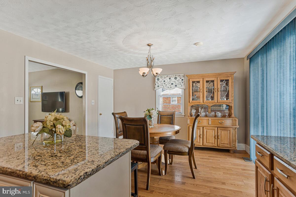 9012 Phyllis Drive Clinton, MD 20735 - Photo 11 of 33 a view of a dining room with furniture and wooden floor