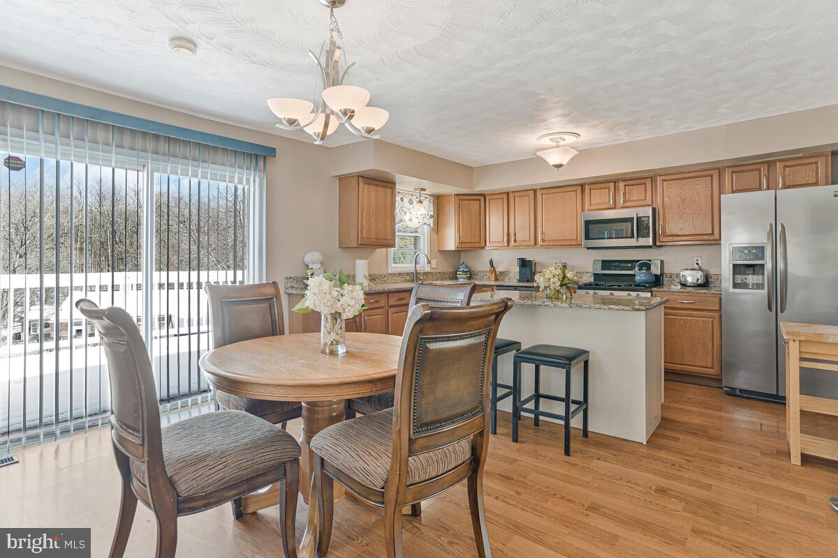 9012 Phyllis Drive Clinton, MD 20735 - Photo 12 of 33 a view of a dining room with furniture window and wooden floor