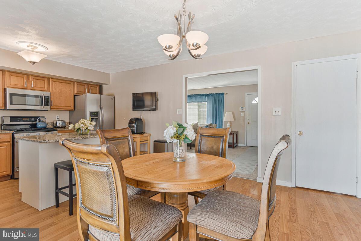 9012 Phyllis Drive Clinton, MD 20735 - Photo 13 of 33 a view of a dining room with furniture and wooden floor