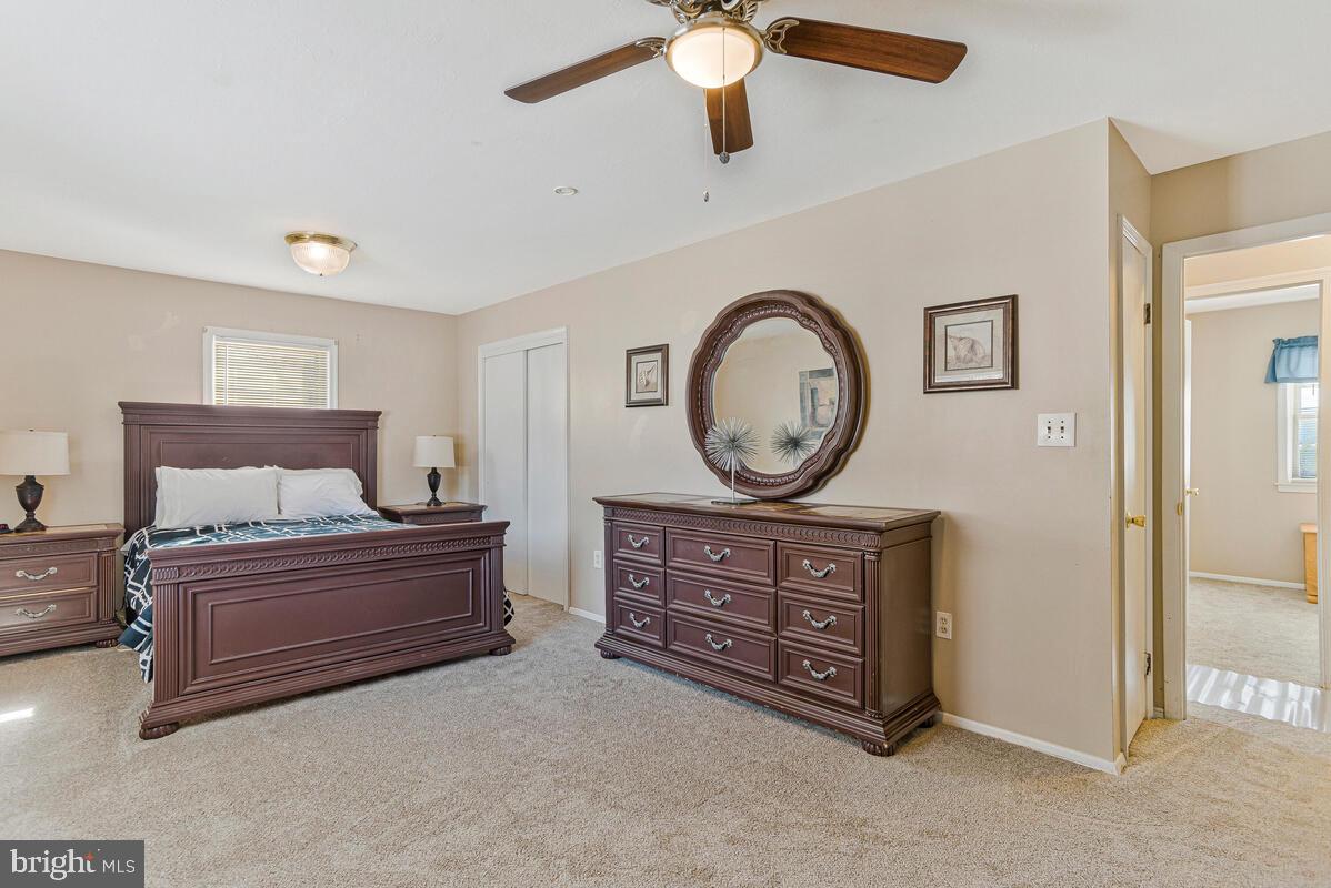 9012 Phyllis Drive Clinton, MD 20735 - Photo 15 of 33 a bedroom with a bed and a chandelier