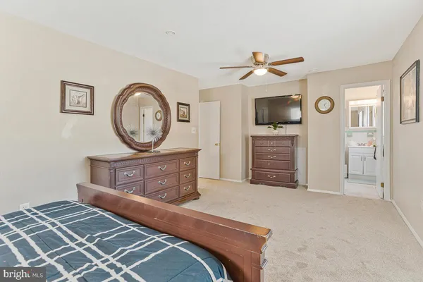 a bedroom with a bed and a television