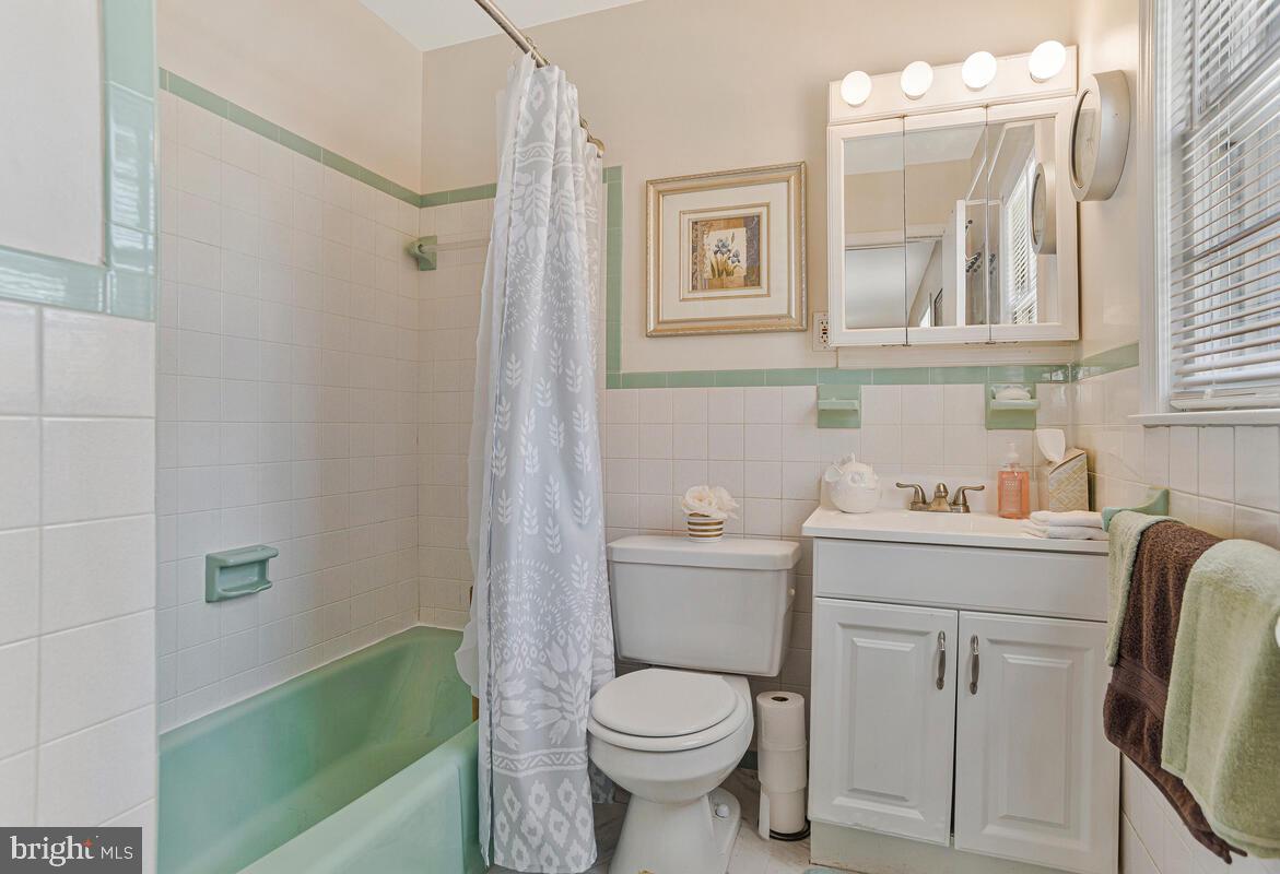9012 Phyllis Drive Clinton, MD 20735 - Photo 17 of 33 a bathroom with a toilet sink and mirror