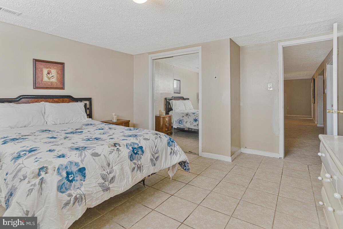 9012 Phyllis Drive Clinton, MD 20735 - Photo 25 of 33 a bedroom with a bed and a mirror