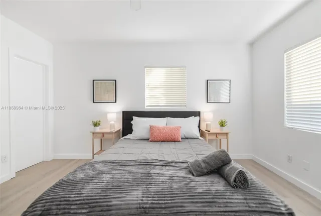 a bedroom with a bed and window