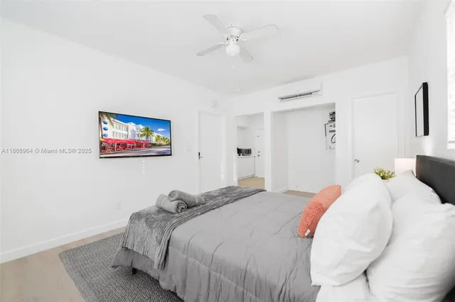 a bedroom with bed and a chandelier
