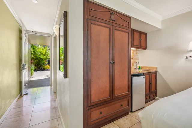 a view of a hallway and closet with mirror