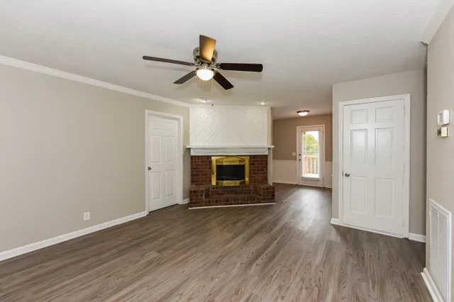 wooden floor in an empty room with a fireplace