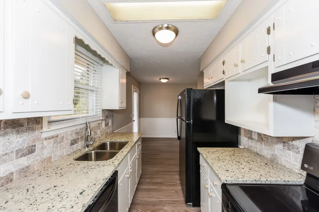 a kitchen with a sink stove and refrigerator