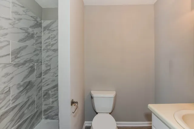 a bathroom with a toilet and a shower