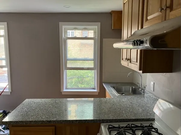 a kitchen with a sink a stove and a window