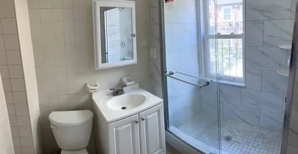 a bathroom with a toilet sink and mirror