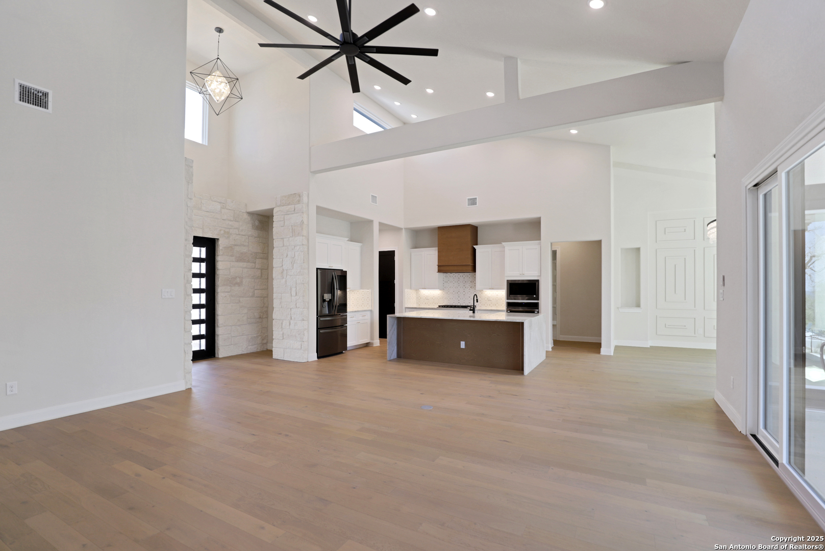 775 Maximino Ridge Bulverde, TX 78163 - Photo 13 of 41 a view of a kitchen with stainless steel appliances a refrigerator and a chandelier