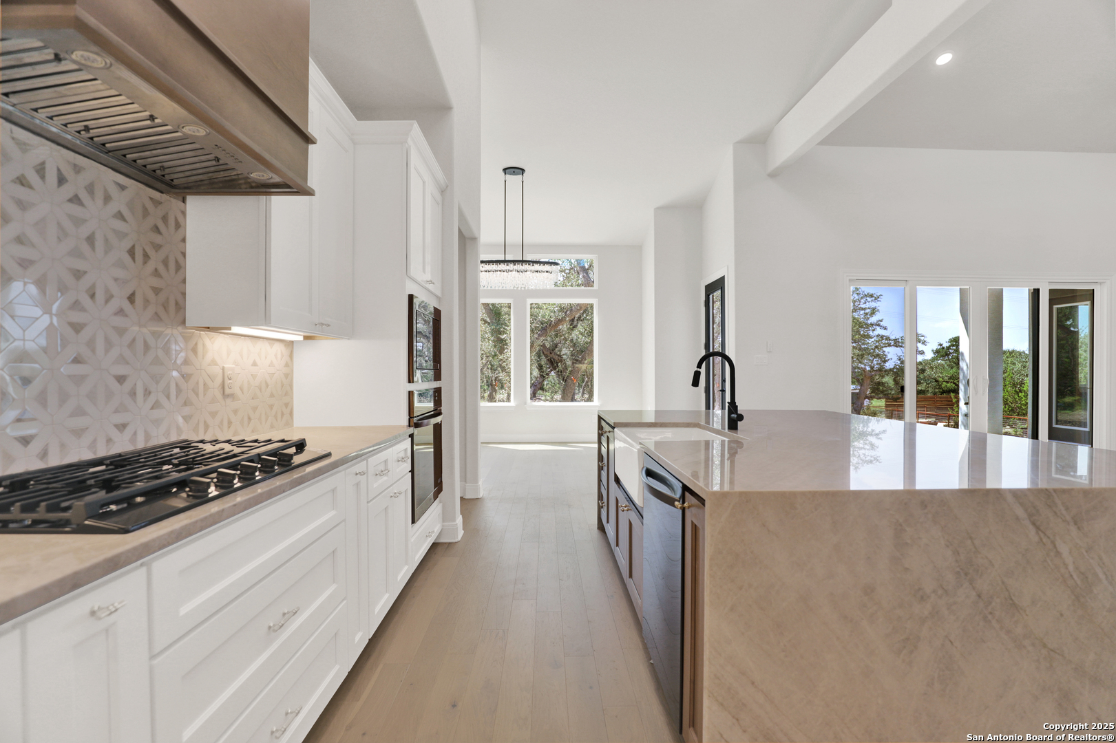 775 Maximino Ridge Bulverde, TX 78163 - Photo 15 of 41 a kitchen with granite countertop a stove and a sink