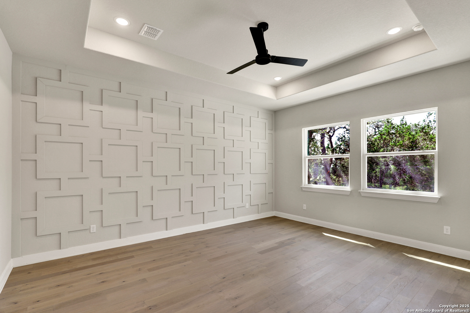 775 Maximino Ridge Bulverde, TX 78163 - Photo 19 of 41 a view of an empty room with a window and wooden floor