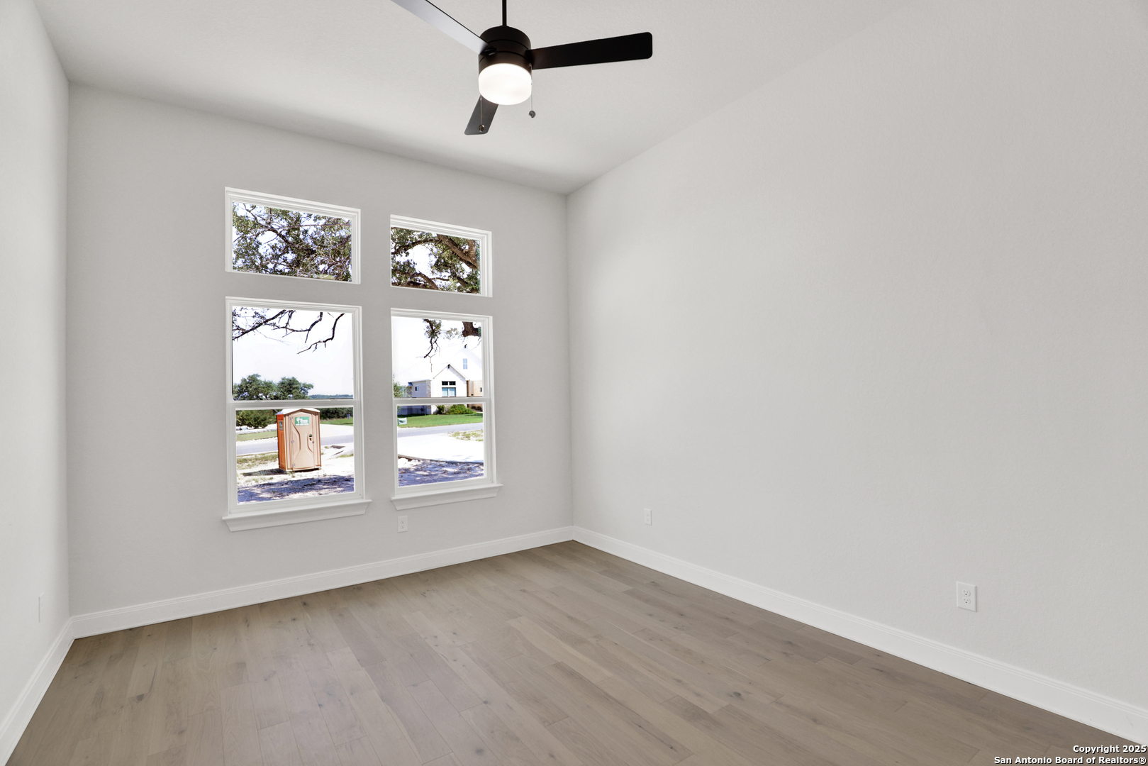 775 Maximino Ridge Bulverde, TX 78163 - Photo 27 of 41 an empty room with windows and ceiling fan