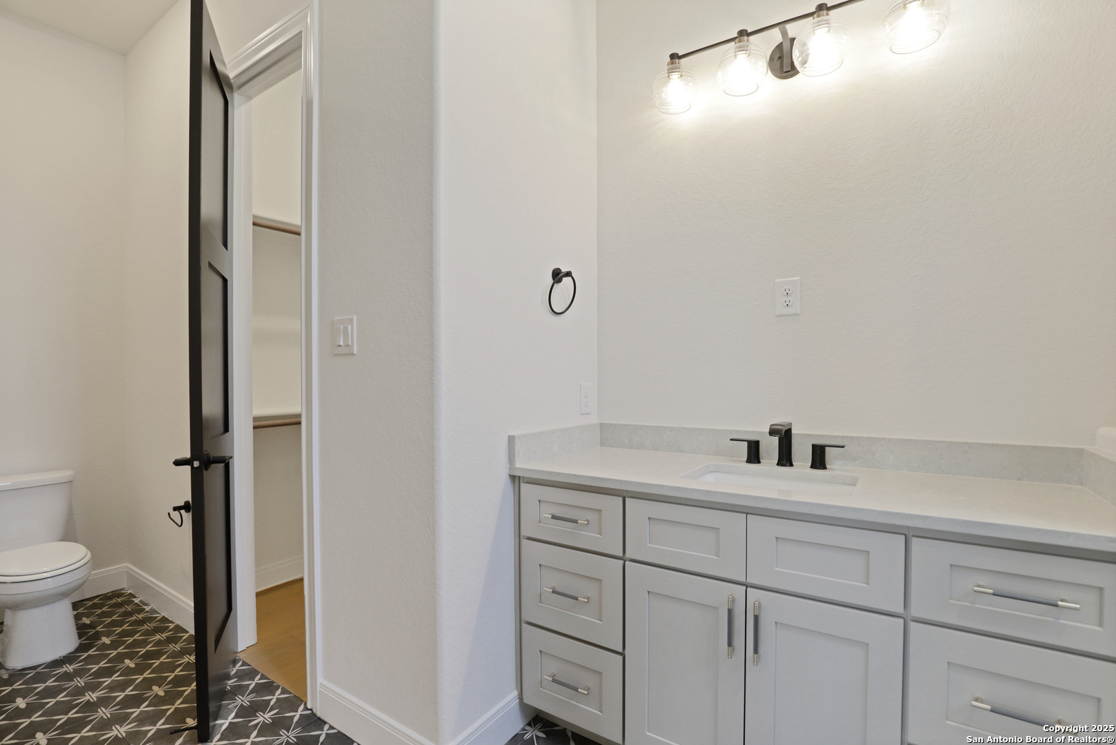 775 Maximino Ridge Bulverde, TX 78163 - Photo 33 of 41 a bathroom with a granite countertop sink a toilet and a mirror
