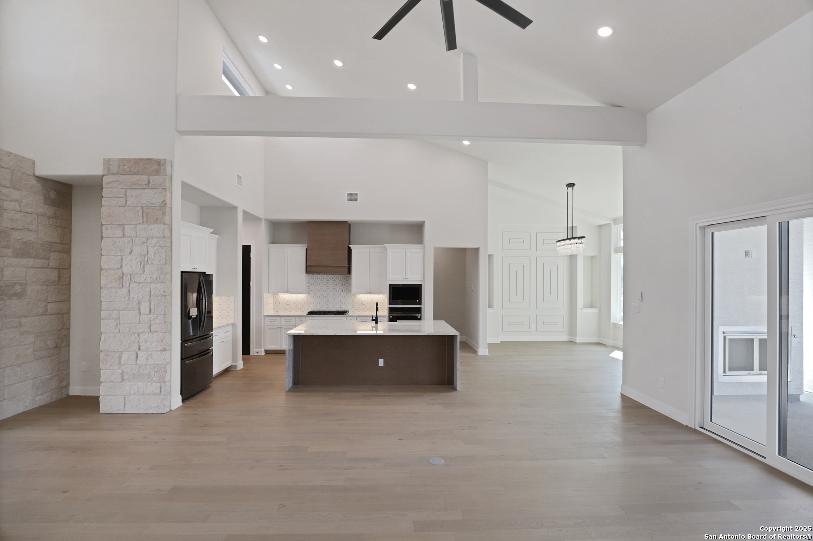 775 Maximino Ridge Bulverde, TX 78163 - Photo 36 of 41 a large room with a kitchen and a chandelier